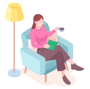 A seated woman reads a book and drinks coffee