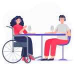 A woman in a wheelchair and a man sit together at a table and record a podcast together.